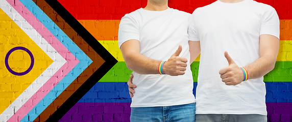 Image showing close up of male gay couple over pride flag