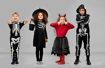 Image showing children in halloween costumes trick-or-treating