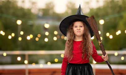 Image showing girl in black witch hat with broom on halloween