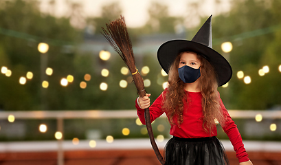 Image showing girl in black mask and halloween costume of witch