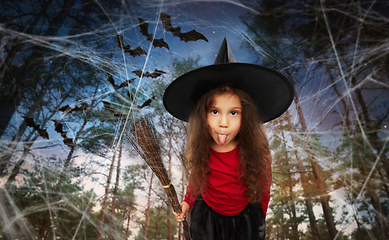 Image showing girl in black witch hat with broom on halloween