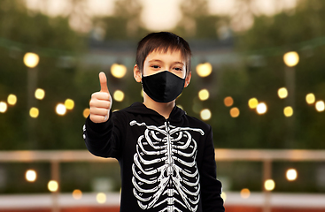 Image showing boy in mask and halloween costume shows thumbs up