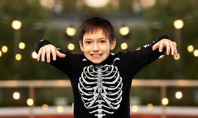 Image showing boy in halloween costume of skeleton frightening