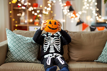 Image showing boy in halloween costume with jack-o-lantern