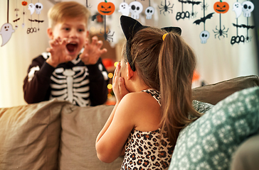 Image showing kids in halloween costumes having fun at home