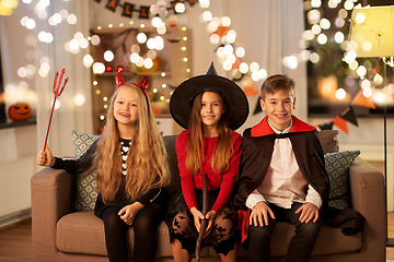 Image showing kids in halloween costumes at home at night