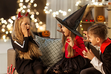 Image showing kids in halloween costumes playing at home