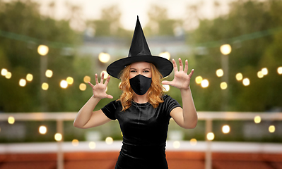 Image showing woman in black mask and halloween costume of witch