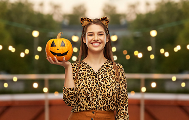 Image showing woman in halloween costume of leopard with pumpkin