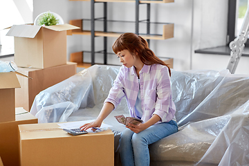 Image showing asian woman moving to new home and counting money