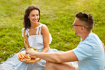 Image showing happy couple having picnic at summer park