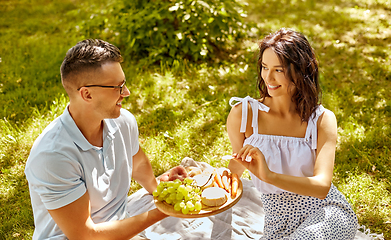 Image showing happy couple having picnic at summer park