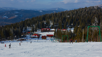 Image showing Blur panoramic view of sport resort for winter vacation. Skies with back light. Warm filter with original sun color tones