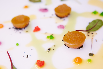 Image showing vegetable jelly with pike caviar dressing with sauce and green leaves