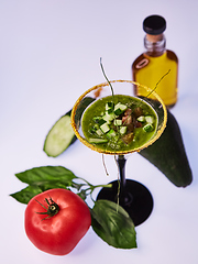 Image showing Cold cucumber soup with avocado and basil. Shallow dof