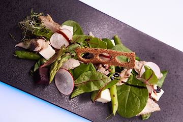 Image showing Green salad with radish and croutons. Shallow dof