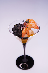 Image showing Appetizer in a glass. Shrimp with vegetable puree with cuttlefish ink. Healthy food. Top view