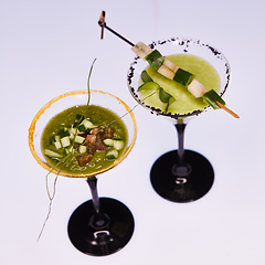 Image showing Cold cucumber soup with avocado and basil. Shallow dof