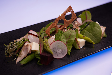 Image showing Green salad with radish and croutons. Shallow dof