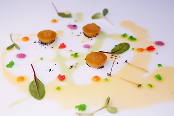 Image showing vegetable jelly with pike caviar dressing with sauce and green leaves