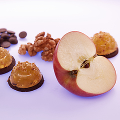 Image showing Fruit jelly with fresh apple. Healthy food. Apple jelly on chocolate with walnuts. Summer dessert with fruit jelly