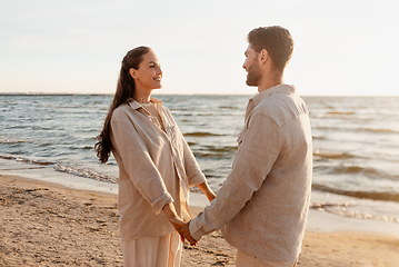 Image showing happy couple holding hands on summer beach