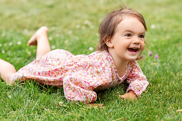 Image showing happy little baby girl lying on grass in summer