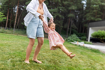 Image showing happy mother playing with baby daughter outdoors