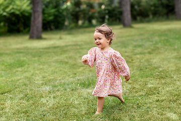 Image showing happy little baby girl running across summer field