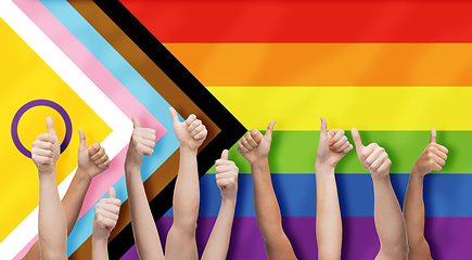 Image showing hands showing thumbs up over progress pride flag