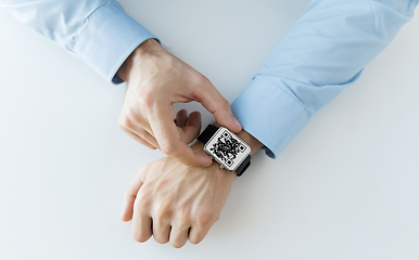 Image showing man's hands with qr code on smart watch