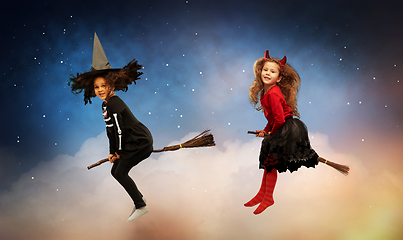 Image showing girl in black witch hat with broom on halloween