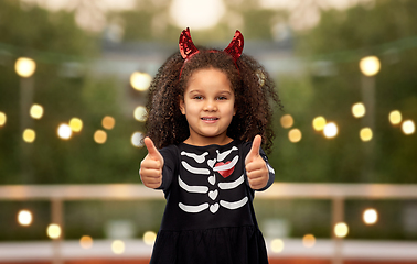 Image showing girl in black dress and devil's horns on halloween