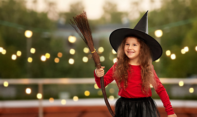 Image showing girl in black witch hat with broom on halloween