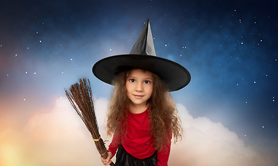 Image showing girl in witch hat with broom on halloween at night