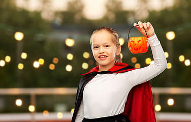 Image showing girl in halloween costume of dracula with pumpkin