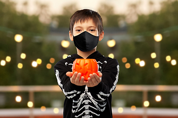 Image showing boy in mask and halloween costume with pumpkin