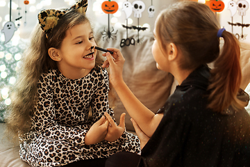 Image showing girls doing face painting on halloween at home