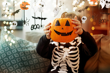 Image showing boy in halloween costume with jack-o-lantern