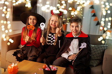 Image showing kids in halloween costumes having fun at home