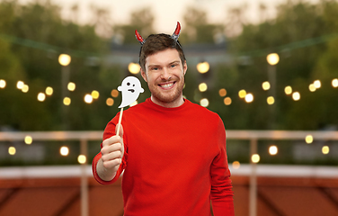 Image showing happy man in halloween costume of devil over grey