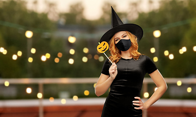 Image showing woman in black mask and halloween costume of witch