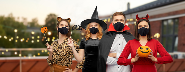 Image showing friends in halloween costumes and black masks