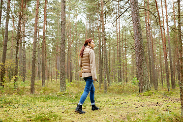 Image showing asian woman picking mushrooms in autumn forest