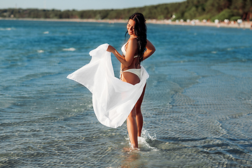 Image showing woman in bikini swimsuit with cover-up on beach