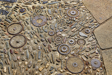 Image showing Floor with pattern from pebbles and rusty metal details