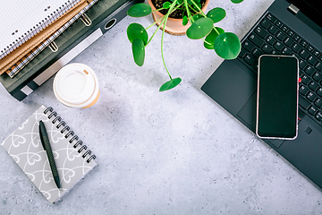 Image showing Modern office desk table with laptop, smartphone and other supplies with cup of coffee