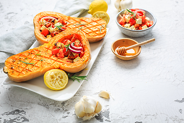 Image showing Halved roasted butternut squash with spicy vegetable filling and feta cheese