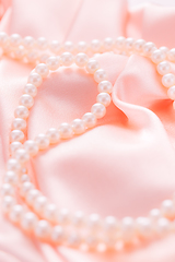 Image showing Pearl necklace on pink satin fabric