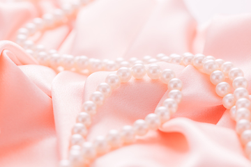 Image showing Pearl necklace on pink satin fabric